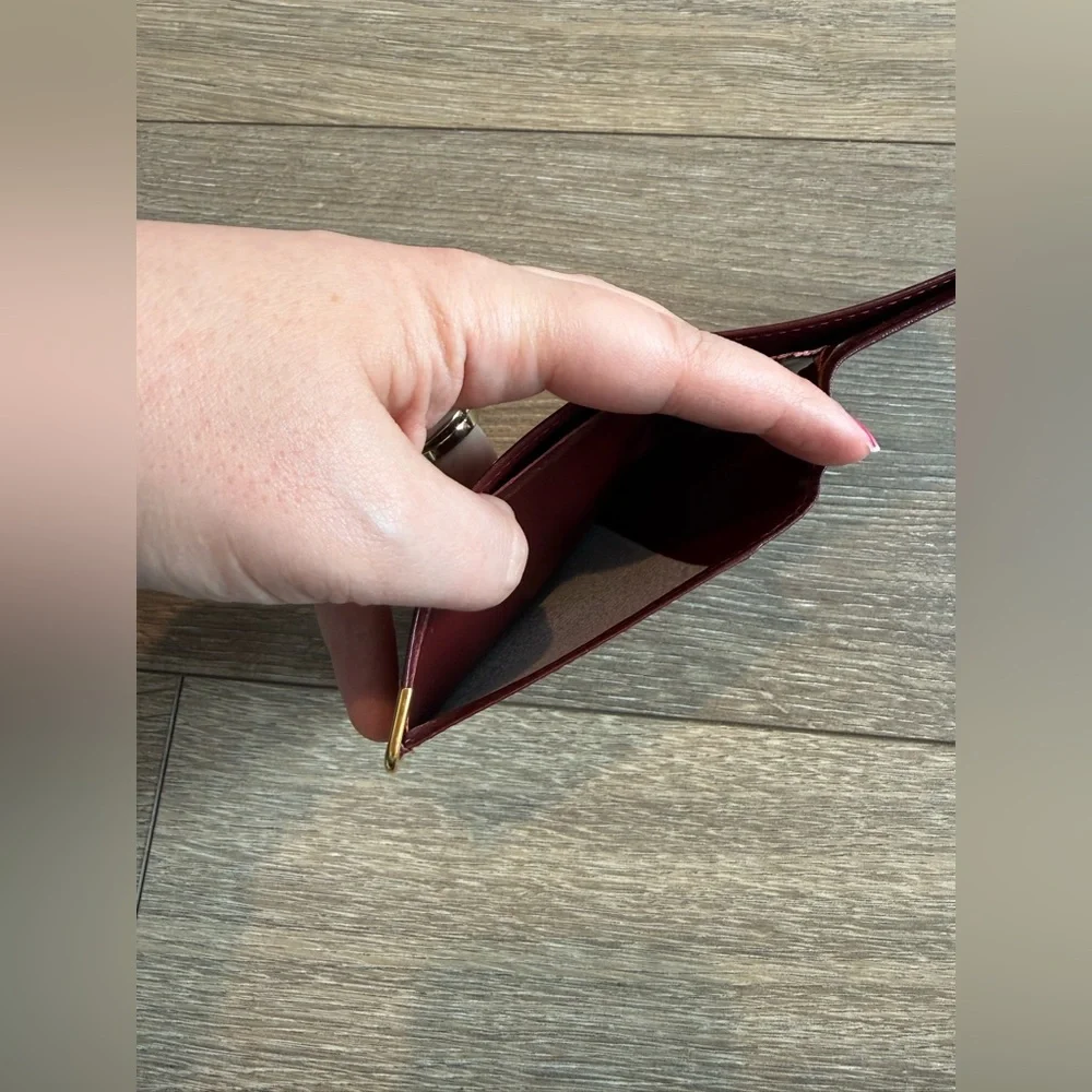 Cartier Men’s Deep Red Leather Bifold with Gold Corners